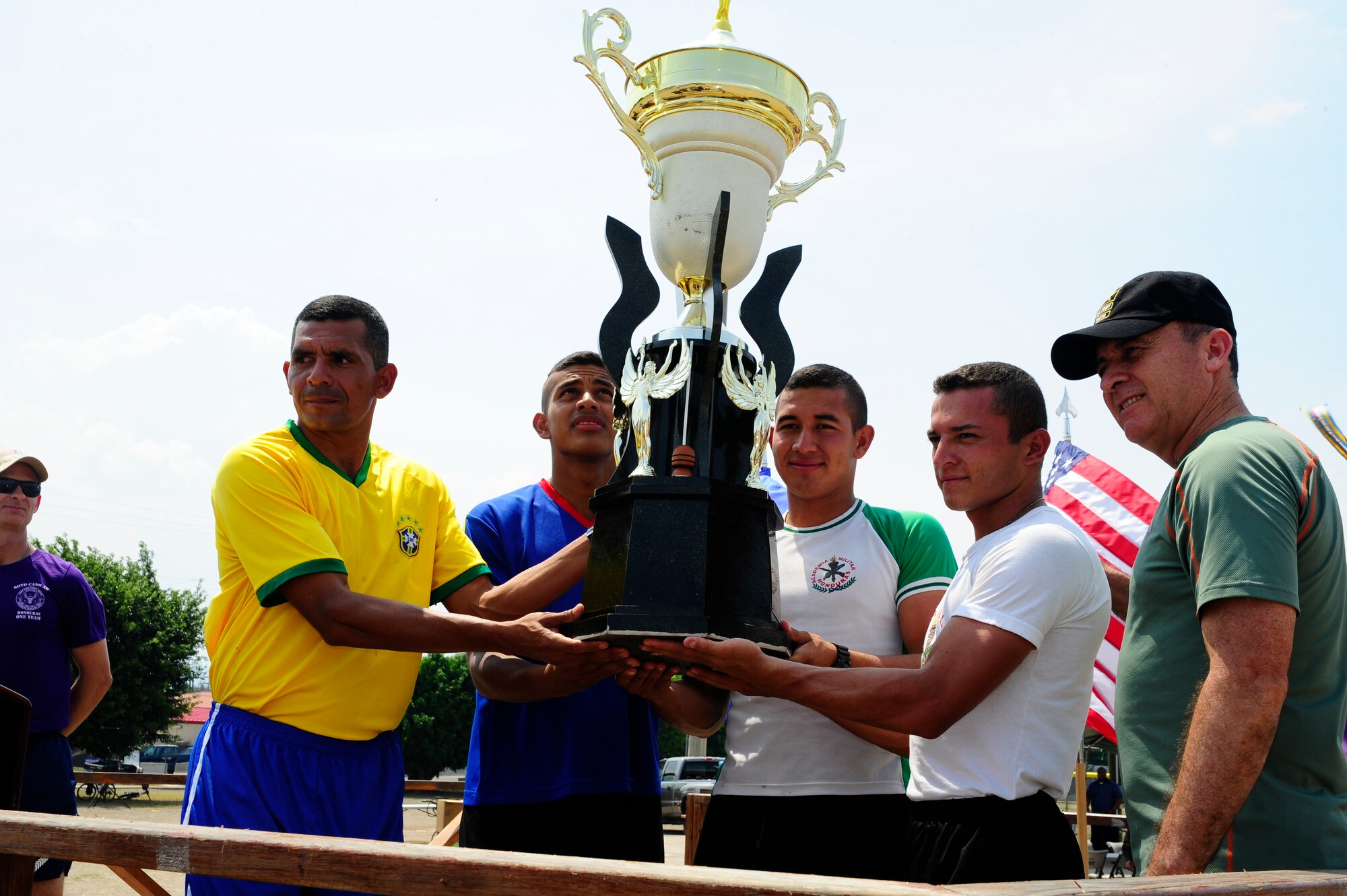 Members of the Honduran Military Training Academy hold the Camaraderie Day trophy and pose with Honduran Army Brig. Gen. Rene Ponce Fonseca, the Honduran Army Forces commander, during the 2016 Camaraderie Day closing ceremony at Soto Cano Air Base, Honduras, May 5, 2016. Following the friendly competitions, the participants ate lunch together, and by the end of the day, the athletes and attendees, through exemplary participation, promoted the spirit of friendship. (U.S. Army photo by Martin Chahin/Released)