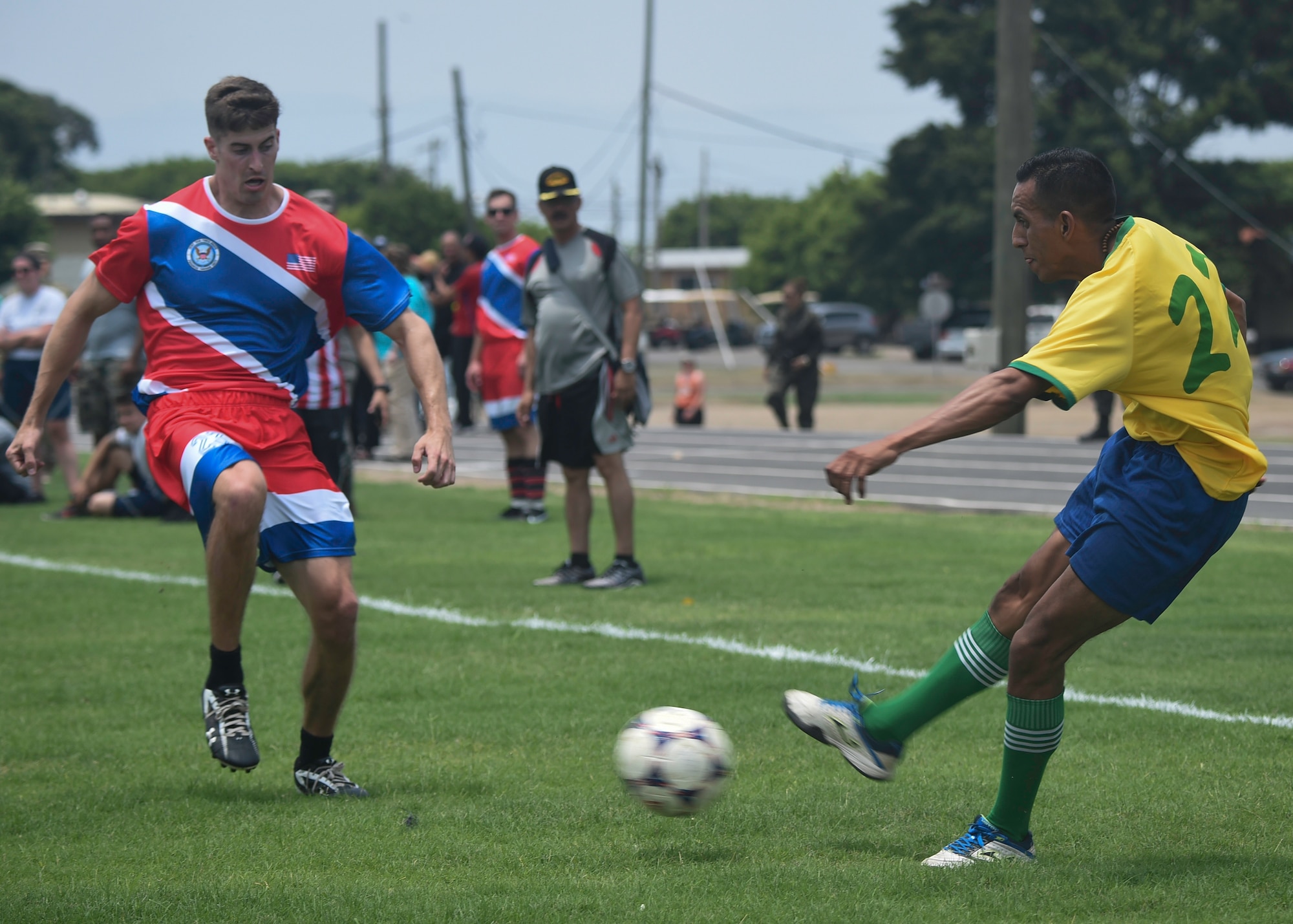 A forward on the Honduran Military Training Academy soccer team passes the ball during the 2016 Camaraderie Day at Soto Cano Air Base, Honduras, May 5, 2016. The Americans stayed stride-for-stride in the beginning of the match before falling to the Hondurans 6-1. (U.S. Air Force photo by Staff Sgt. Siuta B. Ika)