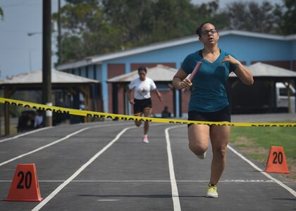 U.S. Air Force Capt. Amber El-Amin, anchor for the Joint Task Force-Bravo women’s 4x200 meter relay team, prepares to cross the finish line ahead of the Honduran Military Training Academy’s team during the 2016 Camaraderie Day at Soto Cano Air Base, Honduras, May 5, 2016. The U.S. team led by the second leg of the race and never gave up the lead from there. (U.S. Air Force photo by Staff Sgt. Siuta B. Ika)