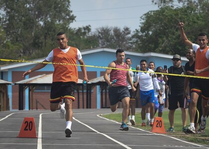 The anchor of the Honduran Military Training Academy men’s 4x200 meter relay team prepares to cross the finish line ahead of the Joint Task Force-Bravo team during the 2016 Camaraderie Day at Soto Cano Air Base, Honduras, May 5, 2016. The Honduran team started off the relay with a big lead, but held on as the U.S. team rallied late. (U.S. Air Force photo by Staff Sgt. Siuta B. Ika)