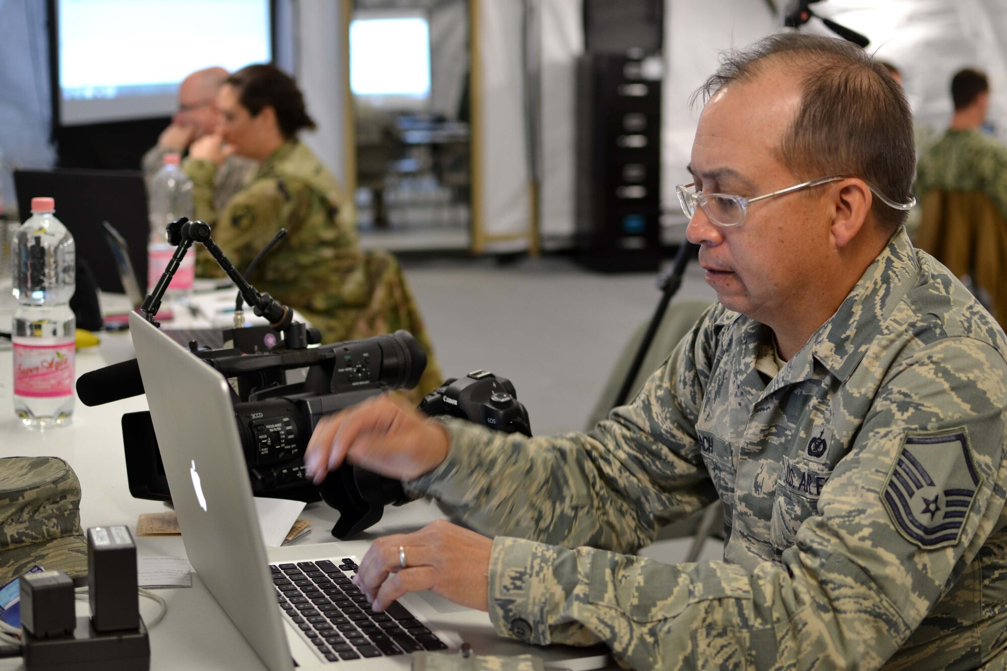 Master Sgt. George Roach, part of the 111th Attack Wing public affairs office at Horsham Air Guard Station, Pennsylvania, edits video product used for exercise Anakonda Response 2016, as well as real-world product showcasing the event to a worldwide audience at Papa Air Base, Hungary, April 27, 2016. Anakonda Response 2016 was planned and generated by the 7th Mission Support Command of the Army Reserve from Kaiserslautern, Germany. (U.S. Air National Guard photo by Tech. Sgt. Andria Allmond)
