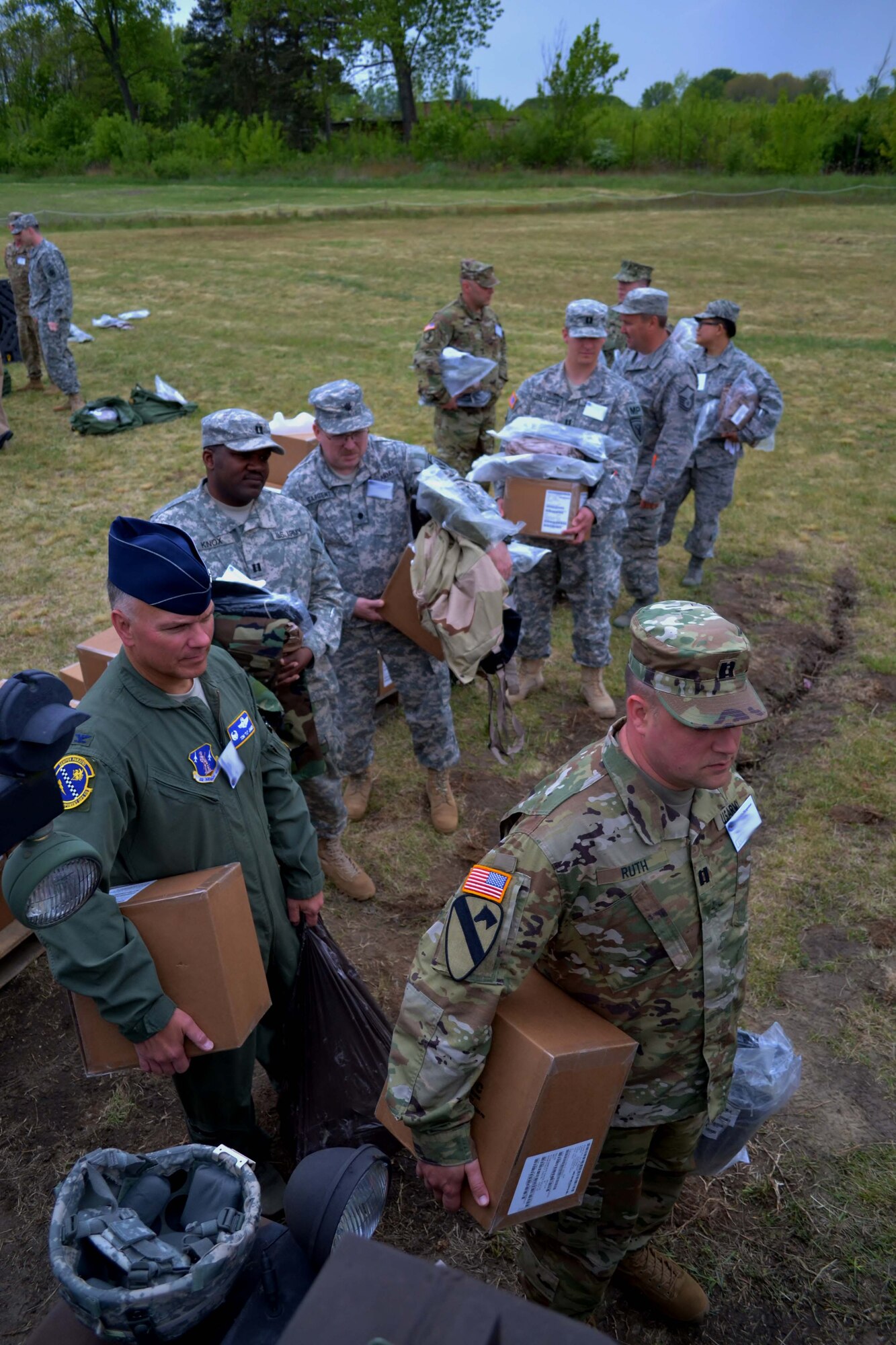 On left, Col. Thomas James, a 111th Attack Wing member at Horsham Air Guard Station, Pennsylvania, stands in line with Soldiers from the 7th Mission Support Command, an Army Reserve unit out of Kaiserslautern, Germany, to receive an M50 Joint Service General Purpose Mask during exercise Anakonda Response 2016 at Papa Air Base, Hungary, May 1, 2016. The scenarios of the exercise were based upon a natural disaster that occurred in Hungary when the retaining wall of a caustic waste reservoir in the country collapsed. (U.S. Air National Guard photo by Tech. Sgt. Andria Allmond)
