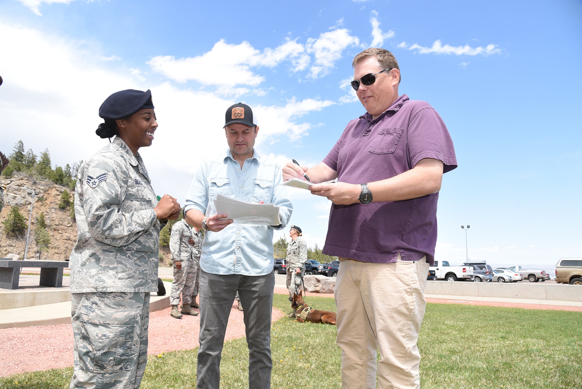 CHEYENNE MOUNTAIN AIR FORCE STATION, Colo. – Kevin Heffernan (right) and Steve Lemme, members of the comedy troupe Broken Lizard and stars of the film “Super Troopers”, sign an autograph for Senior Airman Delmekia Black, 721st Security Forces Squadron during a visit to Cheyenne Mountain Air Force Station on May 6, 2016. Lemme and Heffernan visited and toured the facility, and signed autographs for CMAFS Airmen. The visit was part of the ongoing CMAFS 50th Anniversary celebration. (U.S. Air Force photo by Airman 1st Class Dennis Hoffman)