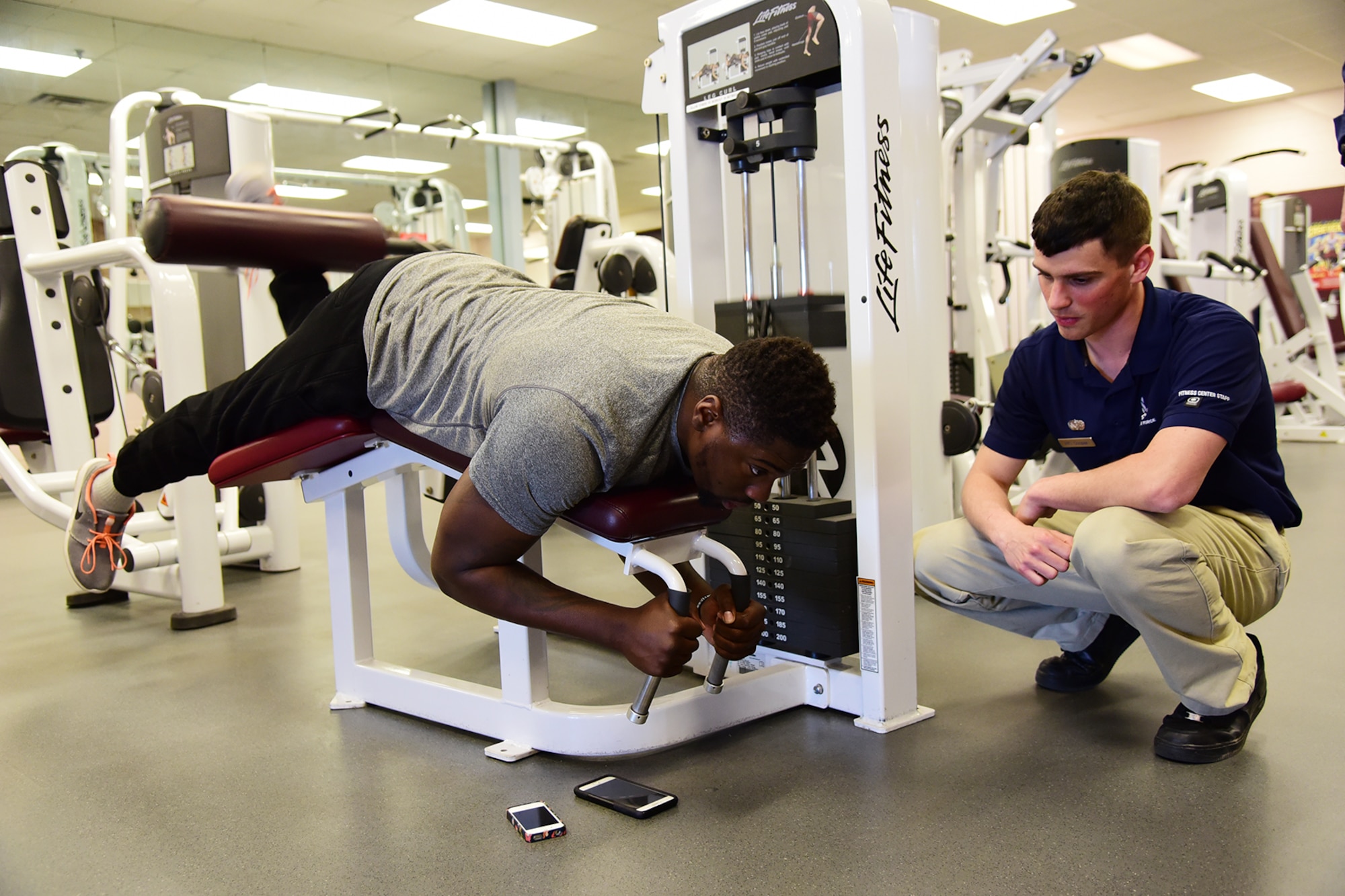 PETERSON AIR FORCE BASE, Colo.- Airman 1st Class Jarod Cooper, 21st Force Support Squadron fitness specialist, monitors a patron’s correct form and breathing during a workout session May 3, 2016. Cooper is one of 12 fitness specialists trained in conducting the five-point fitness test in order to build a personal fitness program for members of Team Pete.  (U.S. Air Force photo by Staff Sgt. Amber Grimm)