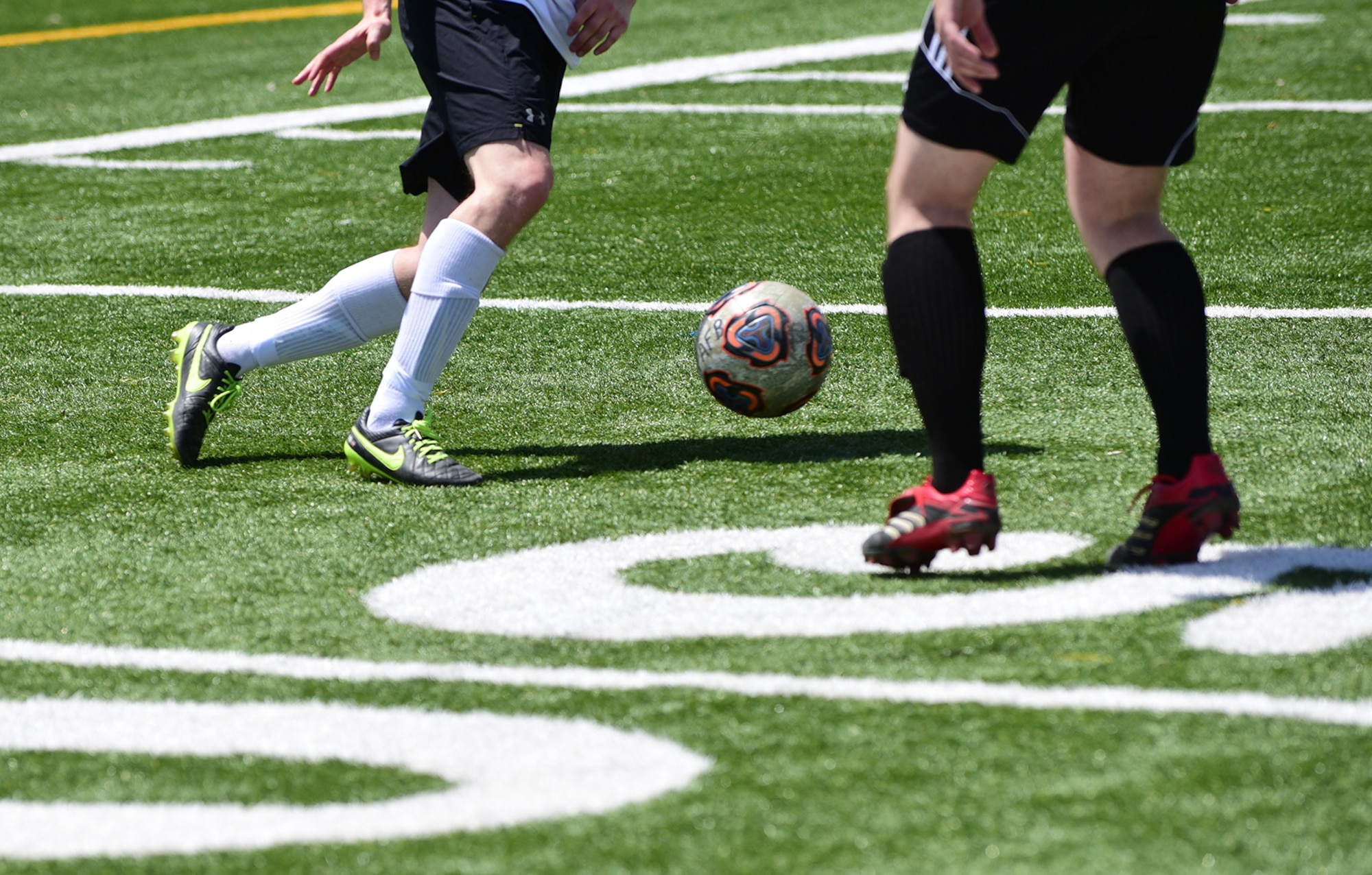 PETERSON AIR FORCE BASE, Colo.- Two soccer players battle for control of the ball during an intramural soccer game May 5, 2016.  Twelve different teams from across the base will compete for the title of champion in the coming months.   (U.S. Air Force photo by Staff Sgt. Amber Grimm)