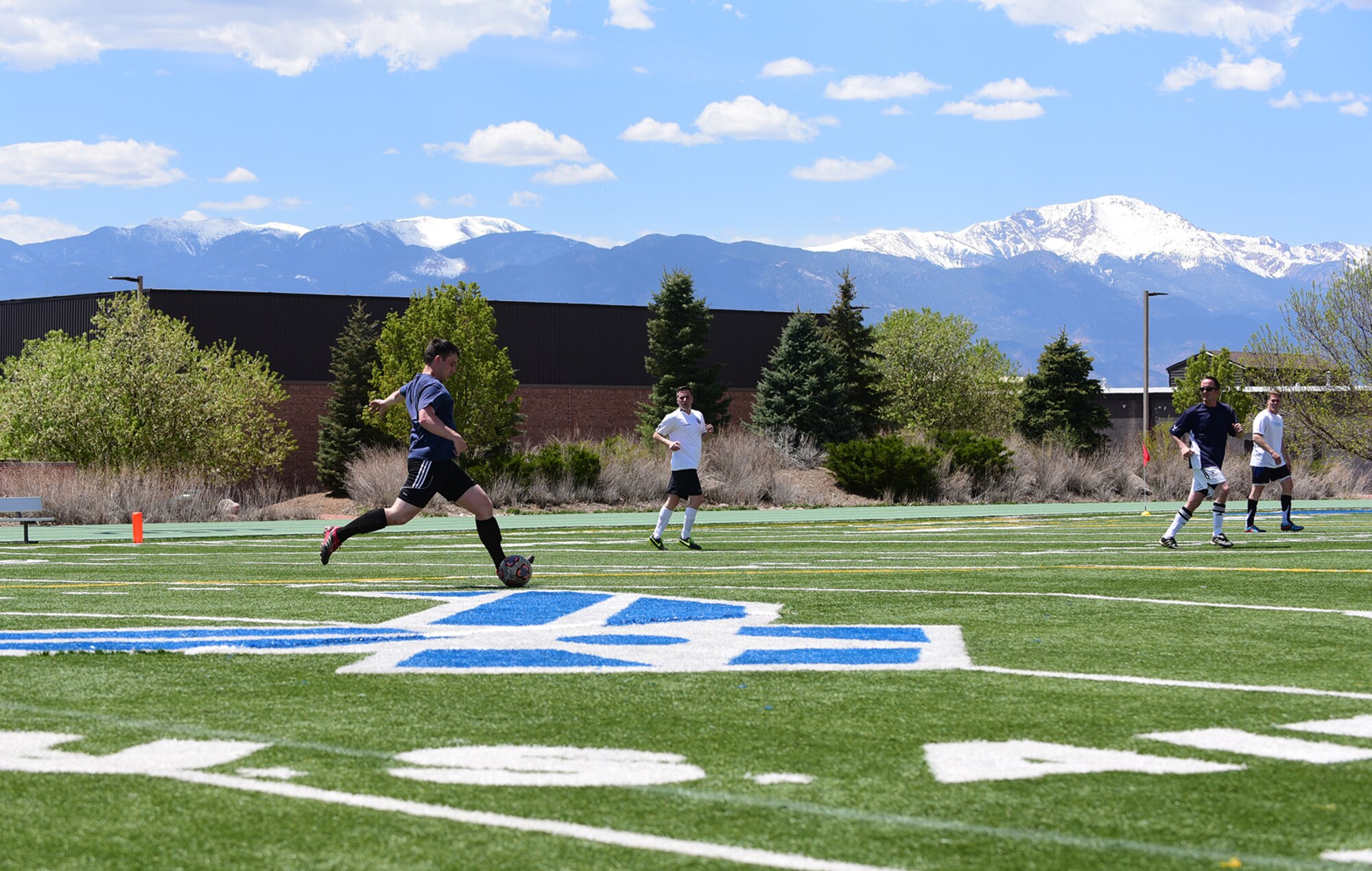 PETERSON AIR FORCE BASE, Colo.-  Airman 1st Class Dennis Hoffman, 21st Space Wing Public Affairs photojournalist, prepares to pass the ball to a teammate during the intramural soccer match between the 21st SW/Wing Staff Agencies and the 21st Medical Group on May 5, 2016. With the feel of spring in the air the bases intramural sports season is in full swing. (U.S. Air Force photo by Staff Sgt. Amber Grimm)
