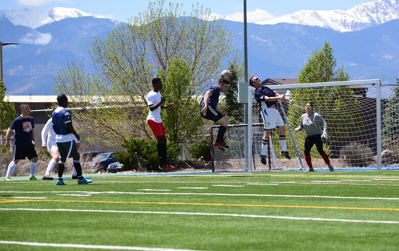 PETERSON AIR FORCE BASE, Colo.- Airman 1st Class Dennis Hoffman, 21st Space Wing Public Affairs photojournalist, uses his head during an intramural soccer match between the 21st SW/Wing Staff Agencies and the 21st Medical Group on May 5, 2016. Twelve different teams from across the base will compete for the title of champion in the coming months.  (U.S. Air Force photo by Staff Sgt. Amber Grimm)