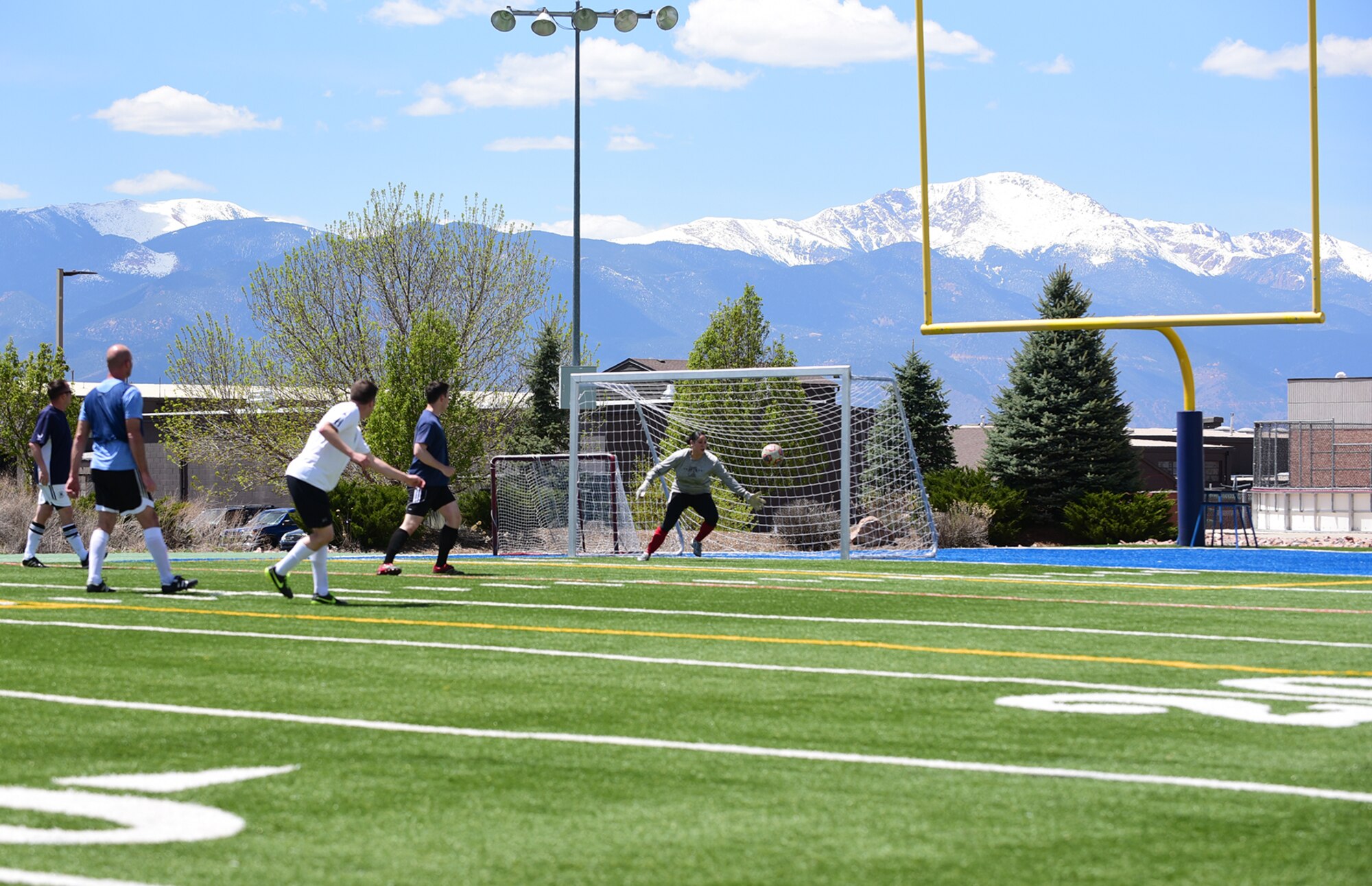 PETERSON AIR FORCE BASE, Colo.- The 21st Space Wing/Wing Staff Agency intramural soccer team battles it out on the field against the 21st Medical Group team May 5, 2016. With the feel of spring in the air the base intramural sports season is in full swing. (U.S. Air Force photo by Staff Sgt. Amber Grimm)