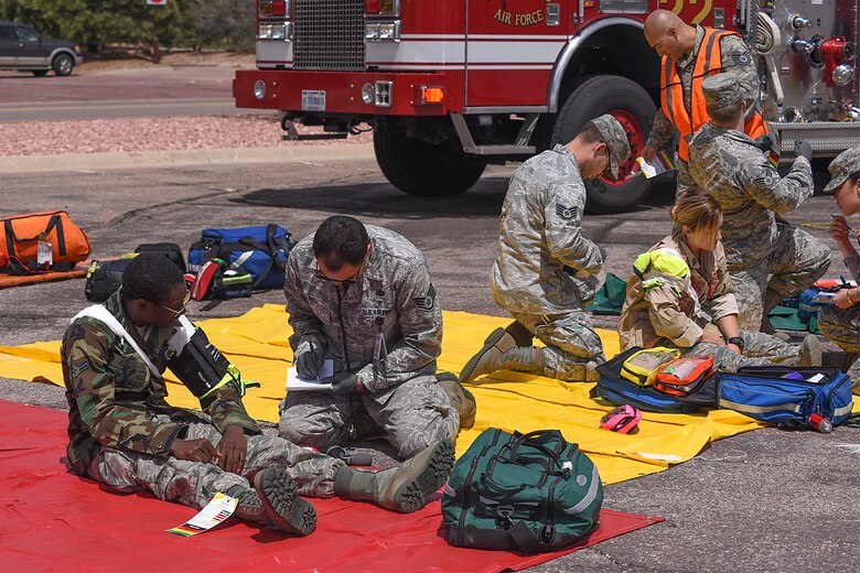 PETERSON AIR FORCE BASE, Colo. -- 21st Space Wing first responders triage victims of a simulated shooter/hostage event during Condor Crest at Peterson Air Force Base, Colo., April 26, 2016.  This exercise is designed to evaluate the wing’s readiness for real-world events. (U.S. Air Force photo by Philip Carter)    