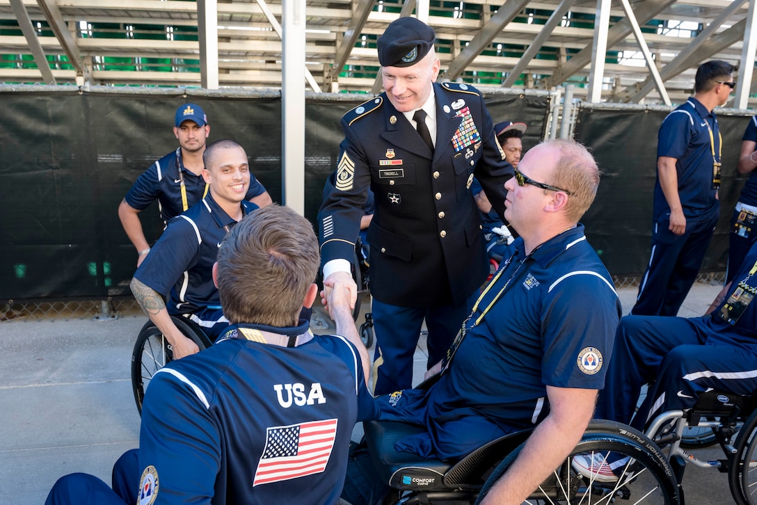 Army Command Sgt. Maj. John W. Troxell, center, senior enlisted advisor to the chairman of the Joint Chiefs of Staff, greets and shakes hands with U.S. team members before the 2016 Invictus Games opening ceremonies in Orlando, Fla., May 8, 2016. DoD photo by Army Staff Sgt. Sean K. Harp