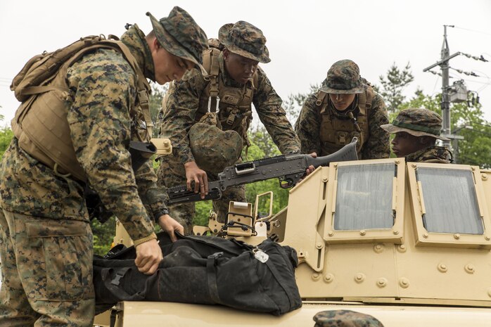 Marines with Marine Wing Support Squadron (MWSS) 171 assemble an M240 Bravo Light-Machine Gun on a high mobility multipurpose wheeled vehicle during exercise Thunder Horse 16.2 at the Japan Ground Self-Defense Force’s Haramura Maneuver Area in Hiroshima, Japan, May 9, 2016. The squadron plans to conduct various drills pertaining to aviation ground support forces, aircraft salvage and recovery, convoys, direct refueling, recovery and general engineering operations, establishing a tactical motor pool, providing air operations and planning expeditionary fire rescue services. The exercise focuses on reinforcing skills that Marines learned during Marine Combat Training and throughout their military occupational specialty schooling in order to maintain situational readiness. (U.S. Marine Corps photo by Lance Cpl. Aaron Henson/Released)