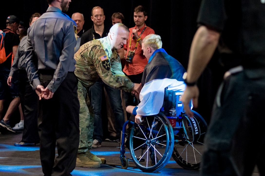 Army Command Sgt. Maj. John W. Troxell, center left, senior enlisted advisor to the chairman of the Joint Chiefs of Staff, greets and shakes hands with an athlete during the 2016 Invictus Games opening ceremonies in Orlando, Fla., May 9, 2016. DoD photo by Army Staff Sgt. Sean K. Harp