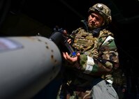 Tech. Sgt. Rick Porto, 51st Civil Engineer Squadron explosive ordnance disposal logistics section chief, loads his weapon during a training exercise at Osan Air Base, Republic of Korea, May 11, 2016. 51st CES Airmen went through a series of stations covering wartime survivability skills, including proper weapons handling and safety during Exercise Beverly Herd 16-01. (U.S. Air Force photo by Senior Airman Victor J. Caputo/Released)