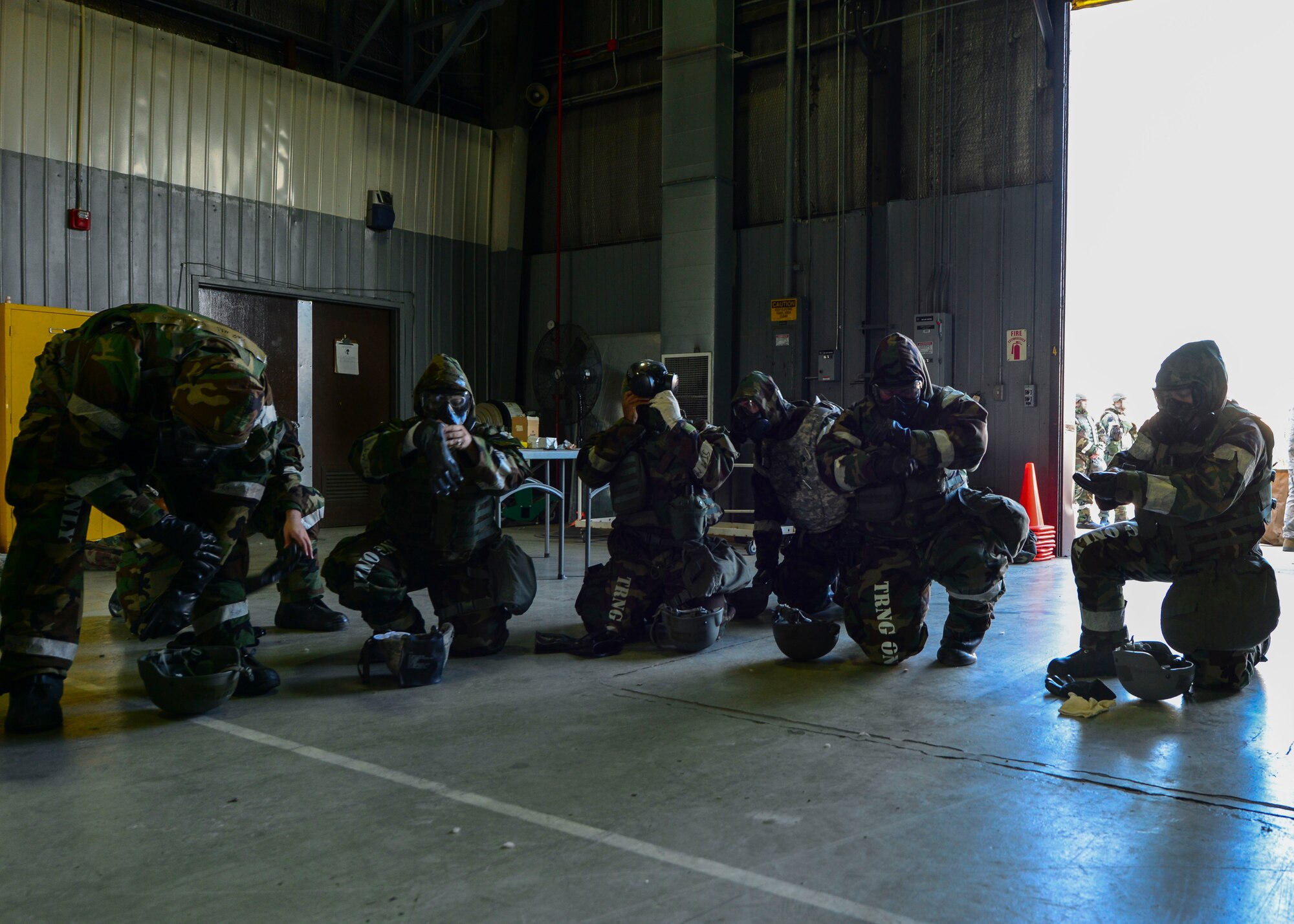 Airmen from the 51st Civil Engineer Squadron don their Mission Oriented Protective Posture gear during a training scenario at Osan Air Base, Republic of Korea, May 11, 2016. The Airmen participated in a decontamination training scenario during Exercise Beverly Herd 16-01. (U.S. Air Force photo by Senior Airman Victor J. Caputo/Released)