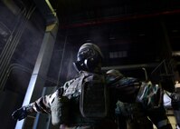 Staff Sgt. Henderson Anthony, 51st Civil Engineer Squadron structural craftsman, stands in a cloud of decontamination powder as his Mission Oriented Protective Gear is decontaminated by his wingman at Osan Air Base, Republic of Korea, May 11, 2016. Dozens of 51st CES Airmen participated in a training scenario covering wartime survivability skills during Exercise Beverly Herd 16-01. (U.S. Air Force photo by Senior Airman Victor J. Caputo)