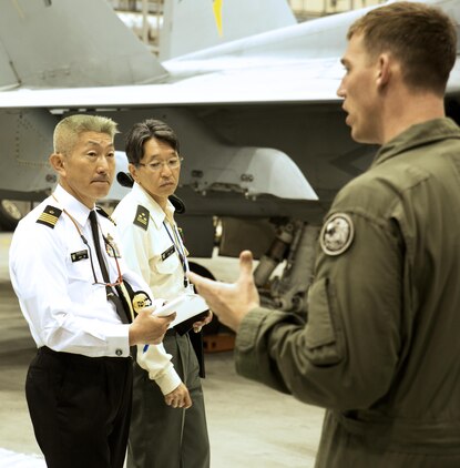U.S. Marine Corps Maj. Elisha Keller, training officer with Marine All-Weather Fighter Attack Squadron (VMFA(AW)) 242, explains air support operations to Japan Ground Self-Defense Force Col. Mitsuhiko Nakadai and Japan Maritime Self-Defense Force Capt. Atsushi Tanaka, instructors from the Japanese Joint Staff College, during their visit to Marine Corps Air Station Iwakuni, Japan, May 9, 2016. The Japanese Joint Staff College instructors visited MCAS Iwakuni to learn about Marine Air-Ground Task Force operations. (U.S. Marine Corps photo by Lance Cpl. Donato Maffin/Released)
