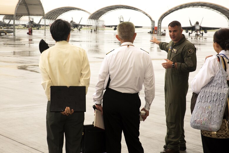U.S. Marine Corps Lt. Col. William Millet, Marine Aircraft Group (MAG) 12 operations officer, shows instructors from the Japanese Joint Staff College the Marine All Weather Fighter Attack Squadron (VMFA(AW)) 242, F/A-18 aprons at Marine Corps Air Station Iwakuni, Japan, May 9, 2016. The Japanese Joint Staff College instructors visited MCAS Iwakuni to learn about Marine Air-Ground Task Force operations. (U.S. Marine Corps photo by Lance Cpl. Donato Maffin/Released)