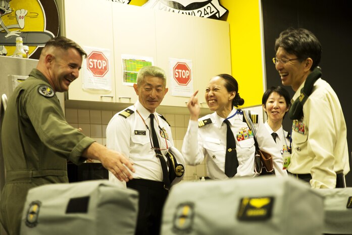 U.S. Marine Corps Lt. Col. William Millet, Marine Air Group (MAG) 12 operations officer, shows instructors from the Japanese Joint Staff College the Marine All Weather Fighter Attack Squadron (VMFA(AW)) 242 briefing room at Marine Corps Air Station Iwakuni, Japan, May 9, 2016. The Japanese Staff College instructors visited MCAS Iwakuni to learn about Marine Air-Ground Task Force operations. (U.S. Marine Corps photo by Lance Cpl. Donato Maffin/Released)