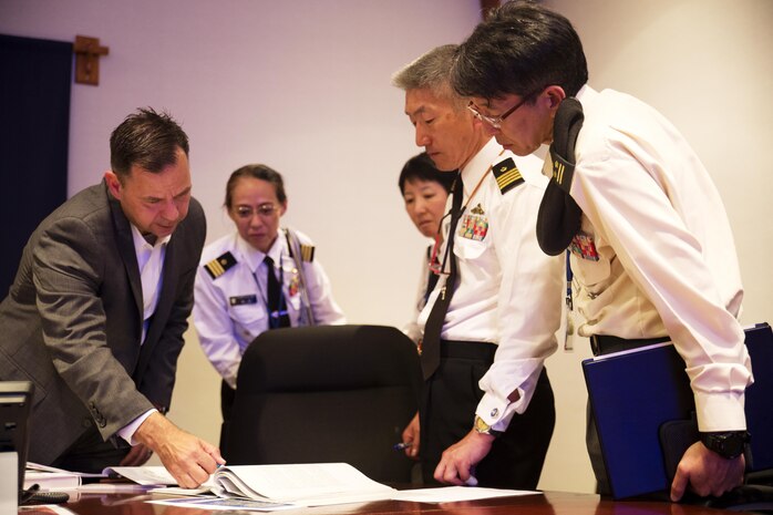 U.S. Marine Corps Lt. Col. Gary W. Thomason, exeutive officer of Marine Corps Air Station Iwakuni, discusses military operations with Japan Ground Self-Defense Force Col. Mitsuhiko Nakadai, Japan Maritime Self-Defense Force Capt. Atsushi Tanaka, JMSDF Capt. Madoka Sato and JMSDF Cmdr. Hiroko Takigawa, instructors from the Japanese Joint Staff College, during their visit to the air station in Iwakuni, Japan, May 9, 2016. The Japanese Joint Staff College instructors visited MCAS Iwakuni to learn about Marine Air-Ground Task Force operations. (U.S. Marine Corps photo by Lance Cpl. Donato Maffin/Released)
 
