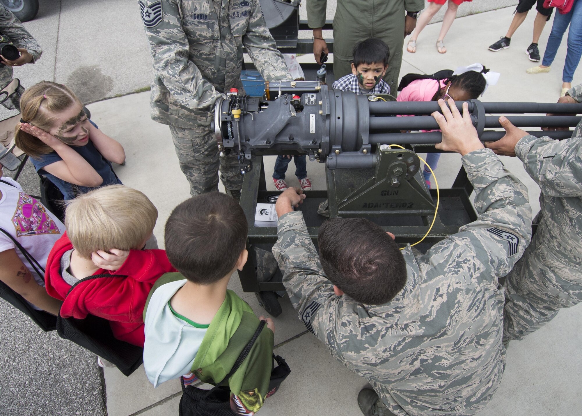 Tech. Sgt. Miguel Garza, 31st Munitions Squadron armament maintenance team chief, shows how a round passes through the chamber of an F-16 Fighting Falcon M61 A1 Vulcan cannon during a Little Wyvern Warriors deployment line May 5, 2016, at Aviano Air Base, Italy. The event was hosted by the 31st Logistics Readiness Squadron and included other base agencies. (U.S. Air Force photo by Airman 1st Class Cory W. Bush/Released)