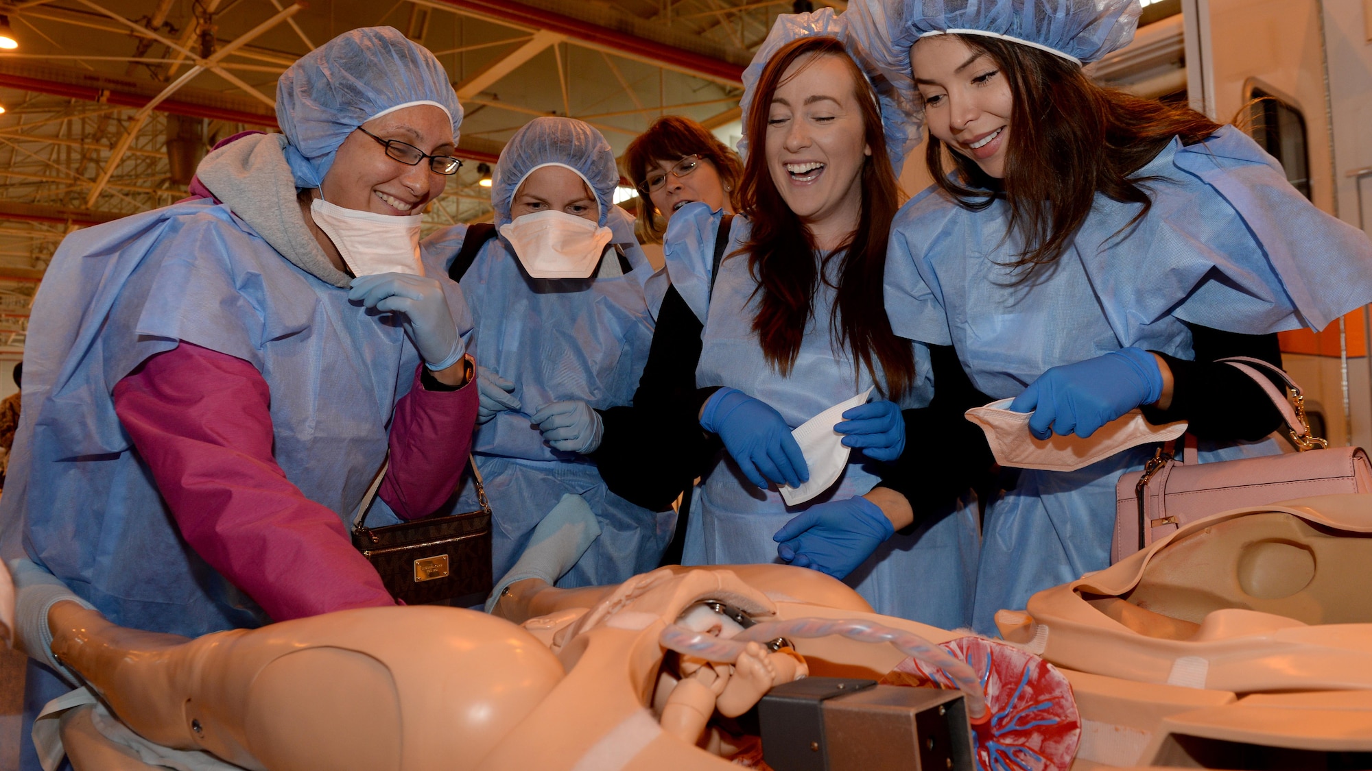 Spouses participate in a hands-on medical demonstration during the first wing-led Spouses Appreciation Day tour, May 10, 2016, at Aviano Air Base, Italy. The day’s events recognized military and civilian employee spouses and included a tour of several on-base locations. (U.S. Air Force photo by Airman 1st Class Cary Smith/Released)