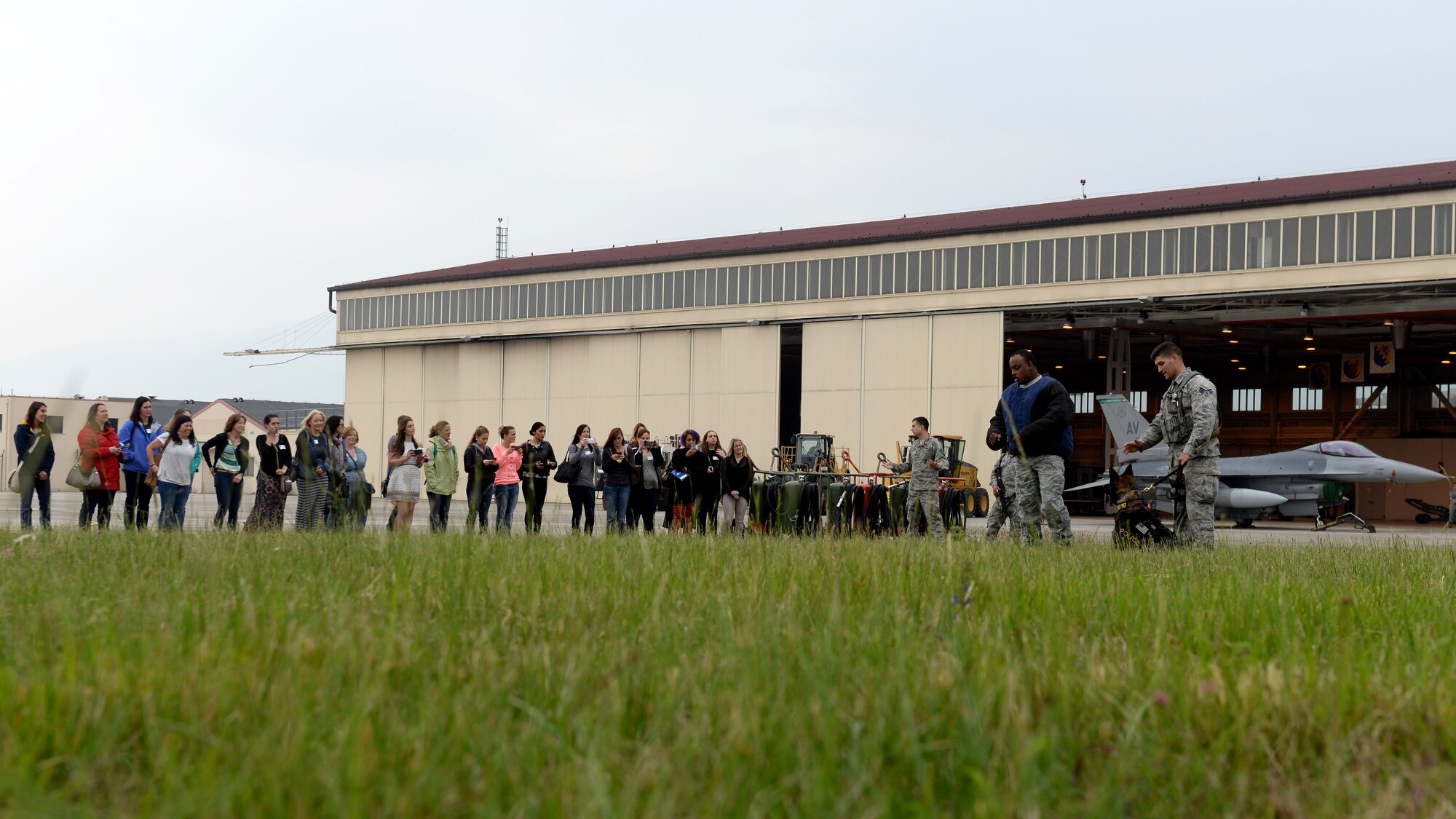 The 31st Security Forces Squadron showcases a military working dog demonstration during the first wing-led Spouses Appreciation Day tour, May 10, 2016, at Aviano Air Base, Italy. The day’s events recognized military and civilian employee spouses and included a tour of several on-base locations. (U.S. Air Force photo by Airman 1st Class Cary Smith/Released)