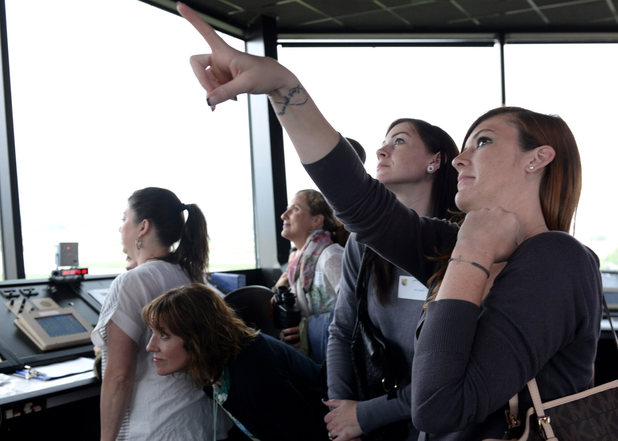 Spouses watch an F-16 Fighting Falcon land during the first wing-led Spouses Appreciation Day tour, May 10, 2016, at Aviano Air Base, Italy. The day started with a mission brief and a hands-on look at how Team Aviano completes the mission. (U.S. Air Force photo by Airman 1st Class Cary Smith/Released)