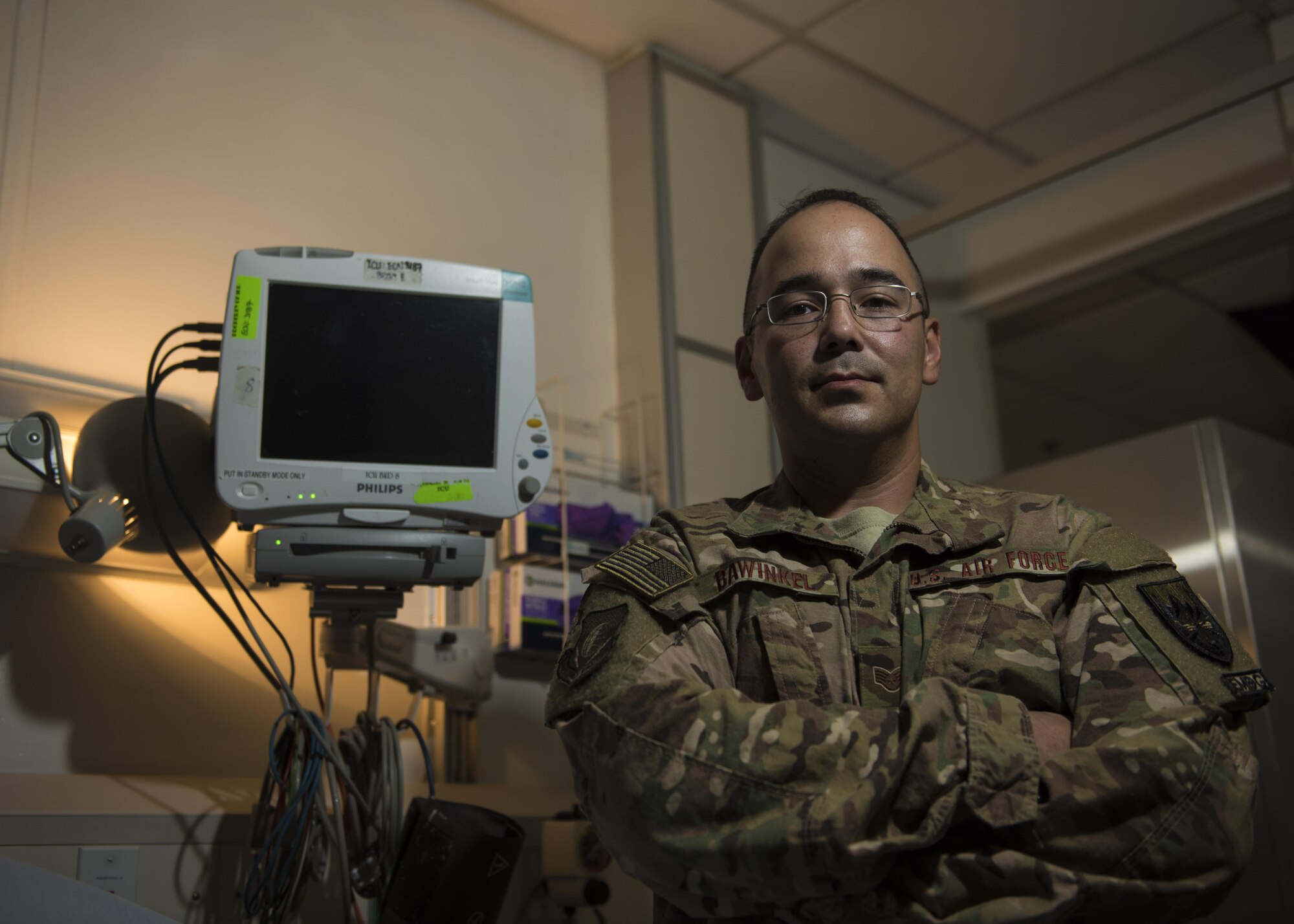 Staff Sgt. David Bawinkel, 455th Expeditionary Medical Operations Squadron aerospace medical service technician, works in the Intensive Care Unit where patients who are the most "trauma written" are placed, Bagram Airfield, Afghanistan, May 10, 2016. Bawinkel, who is deployed as an aerospace medical technician, assists doctors and nurses while caring for patients in a wide range of situations. (U.S. Air Force photo by Senior Airman Justyn M. Freeman)