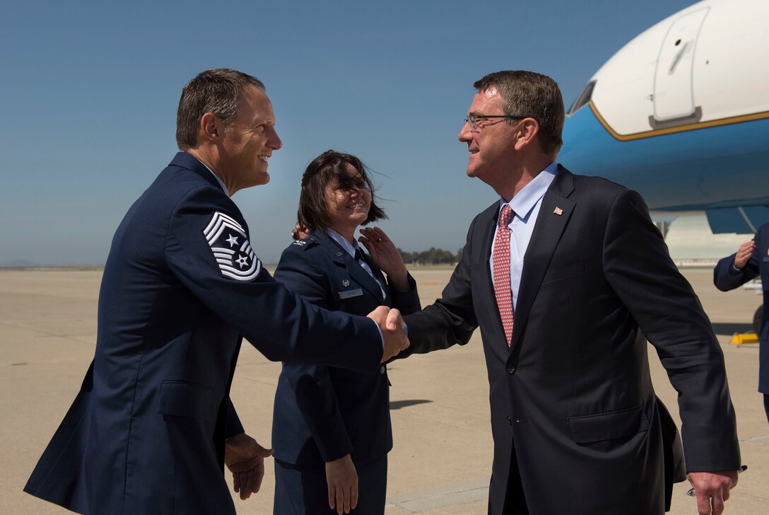 Defense Secretary Ash Carter shakes hands with Air Force Chief Master Sgt. Steven J. Pyszka, command chief of the 129th Maintenance Group, as Air Force Col. Rosemary M. Smith, the unit's commander, looks on as he arrives at Moffett Field near Mountain View, Calif., May 10, 2016. DoD photo by Air Force Senior Master Sgt. Adrian Cadiz