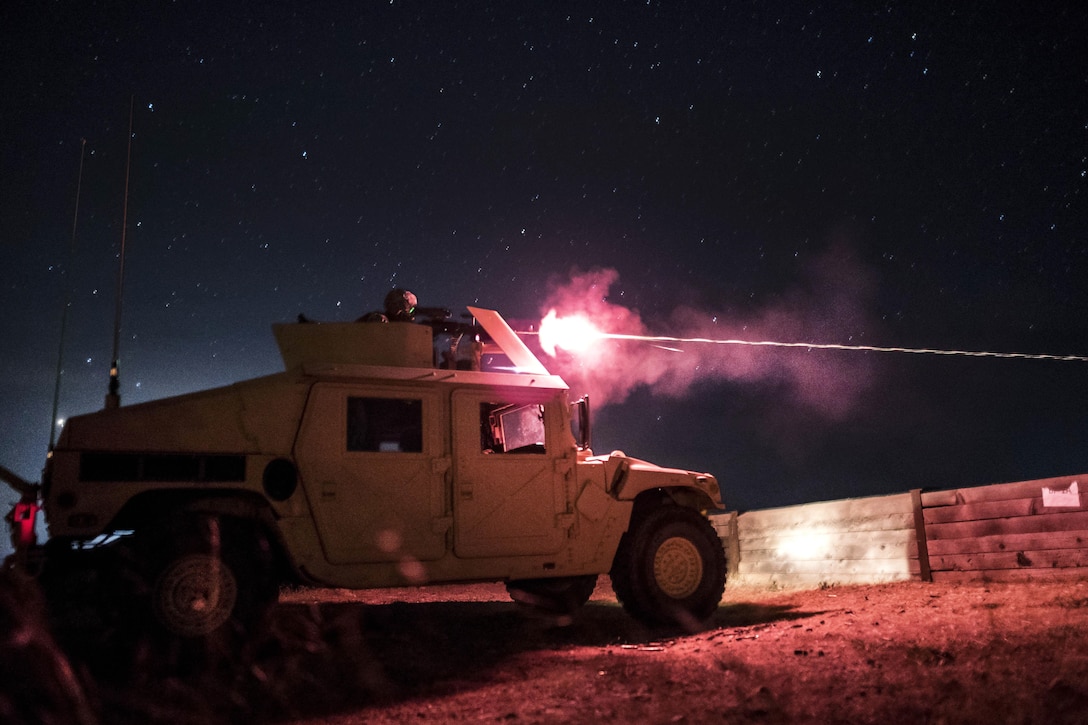 An Army Reserve soldier fires an M240B machine gun mounted on a vehicle turret during a night-fire qualification at Fort Hunter Liggett, Calif., May 3, 2016. Army photo by Master Sgt. Michel Sauret