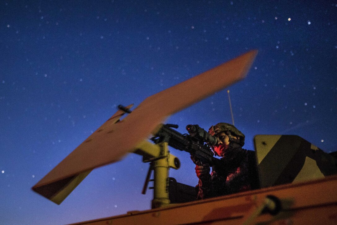 Army Pfc. Ryan Joe scans downrange using a night vision scope on an M240B machine gun before participating in a night-fire qualification at Fort Hunter Liggett, Calif., May 3, 2016. Joe is a military police officer assigned to the 341st Military Police Company. Army photo by Master Sgt. Michel Sauret