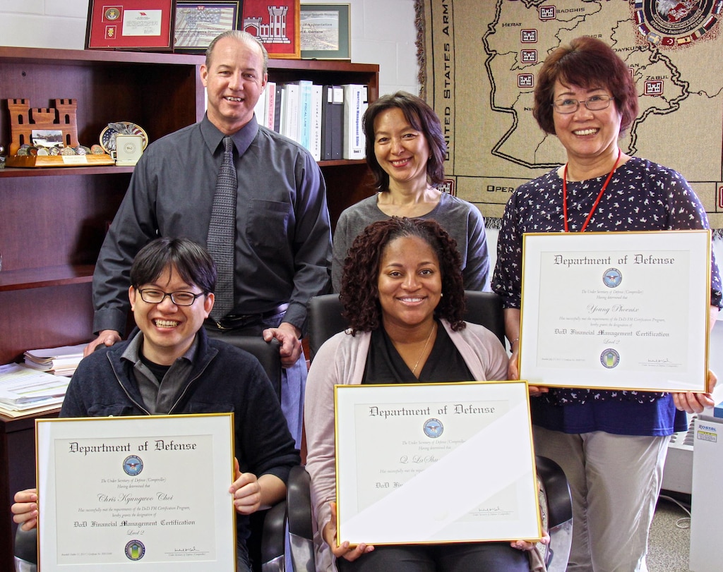 Employees of the Far East District Resource Management Office showcase their DoD Financial Management Certifications.  
Sitting: Chris Choi, LaShun Medlock. Standing: Robert Derrane, Haekyung Cho and Young Phoenix (Young Jin and Sgt. 1st Class Diomedes Tuazon were unavailable).