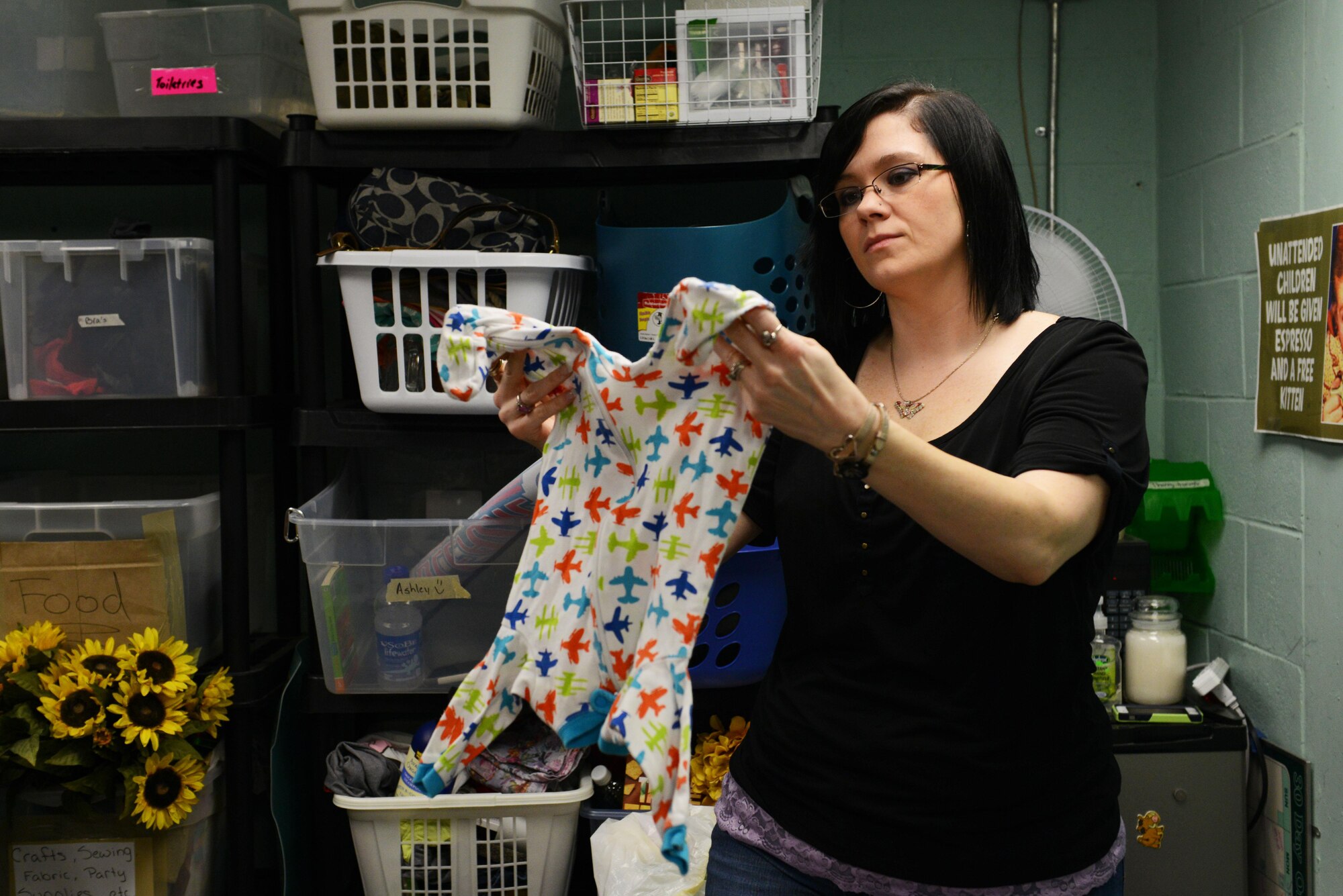 Madeline Kraft, Team Shaw spouse and Shaw Attic co-coordinator, sorts and inspects clothing at the Attic on Shaw Air Force Base, S.C., April 19, 2016. The Attic accepts items such as clothing, household goods and military uniforms under the stipulation the donations are in good condition. (U.S. Air Force photo by Airman 1st Class Destinee Dougherty)