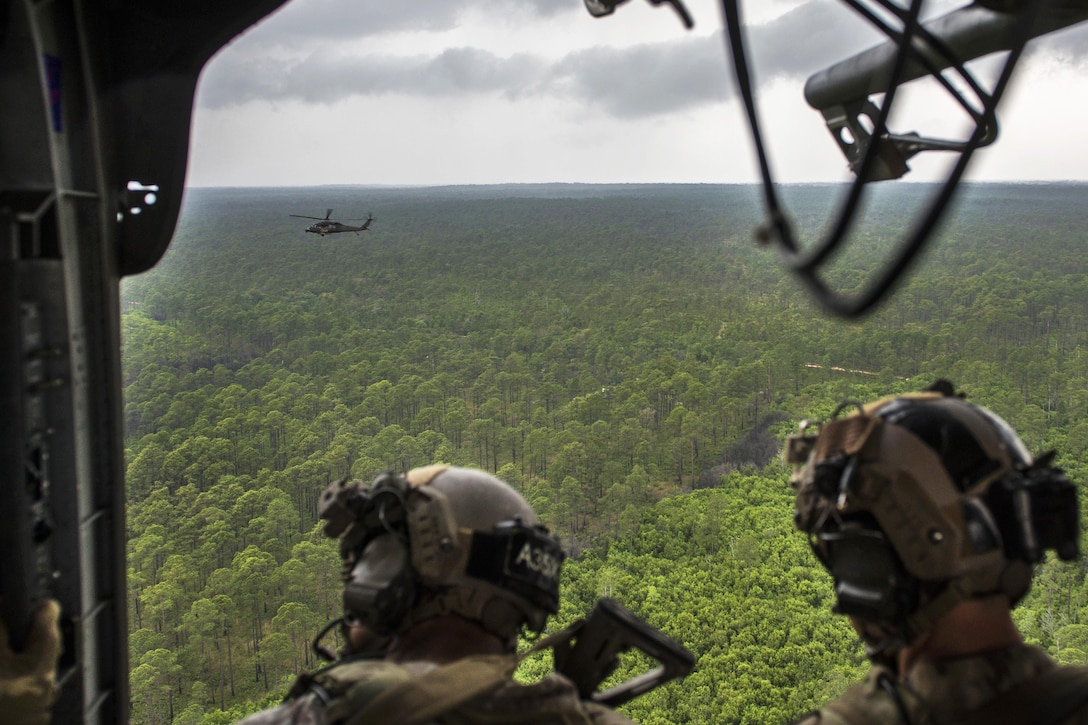 Army Special Forces soldiers travel aboard a UH-60 Black Hawk helicopter over a training range during Emerald Warrior 16 at Hurlburt Field, Fla., May 3, 2016. Air Force photo by Tech. Sgt. Gregory Brook