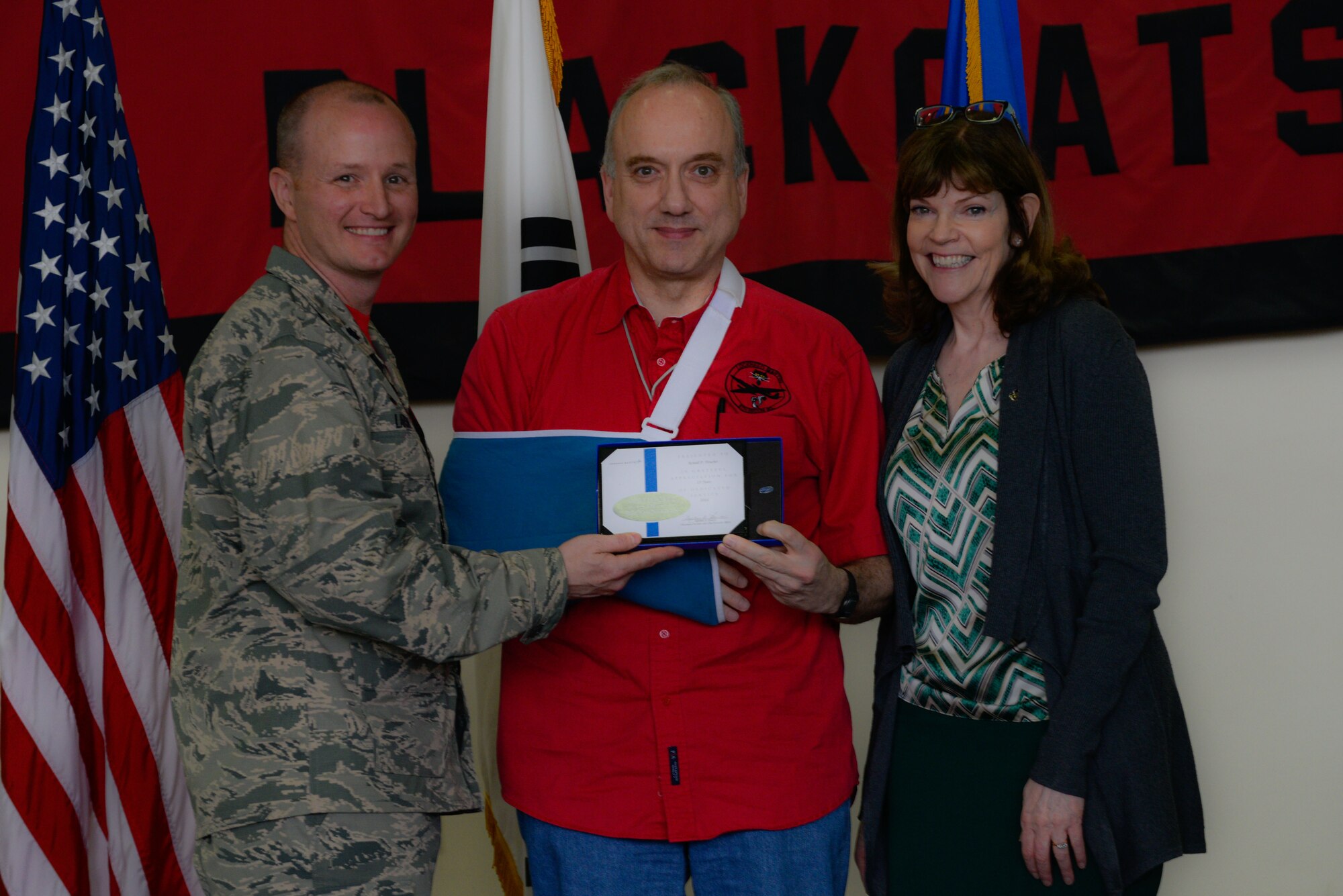 Lt. Col. Todd Larsen, 5th Reconnaissance Squadron commander, presents a certificate of appreciation to Robert Boucher, Lockheed Martin mechanical engineer, during the 40th Anniversary U-2 Ceremony May 6, 2016, at Osan Air Base, Republic of Korea. Larsen thanked Boucher for his contributions to the 5th RS through supporting the U-2 Dragon Lady aircraft. (U.S. Air Force photo by Senior Airman Dillian Bamman/Released)