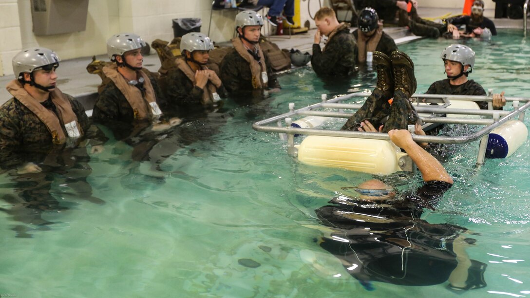 Marines with Marine Medium Tiltrotor Squadron 264 wait to escape the cage during water survival training at Marine Corps Base Camp Lejeune, Apr. 28, 2016. The Marines used a simulated helicopter body while training for different underwater escape scenarios as qualification to be attached to a Marine Expeditionary Unit. 
