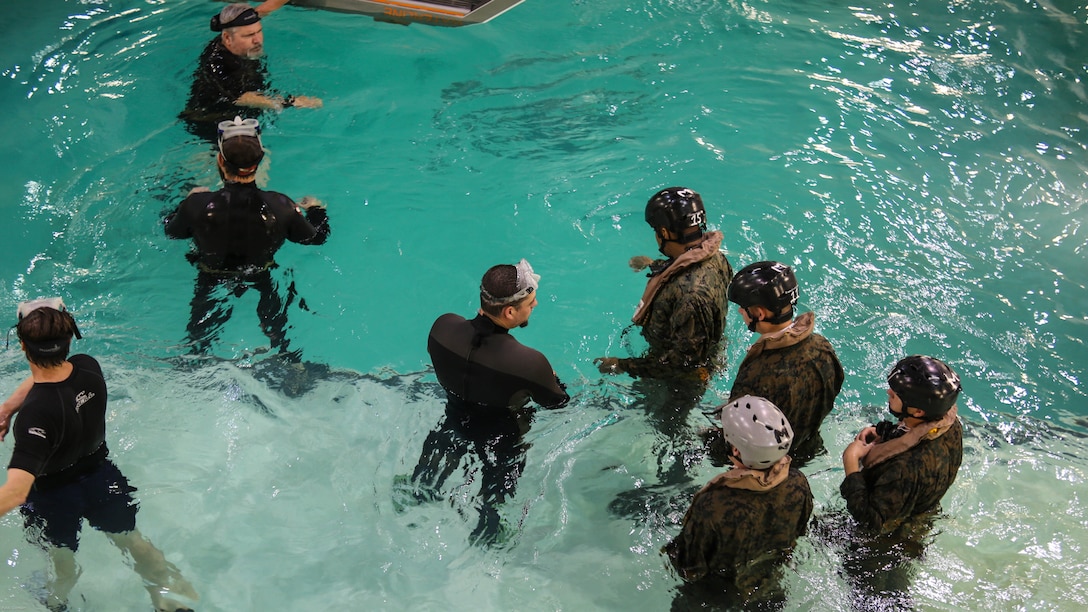 Marines with Marine Medium Tiltrotor Squadron 264 prepare to enter the helo dunker during water survival training at Marine Corps Base Camp Lejeune, Apr. 28, 2016. The Marines used a simulated helicopter body while training for different underwater escape scenarios as qualification to be attached to a Marine Expeditionary Unit. 