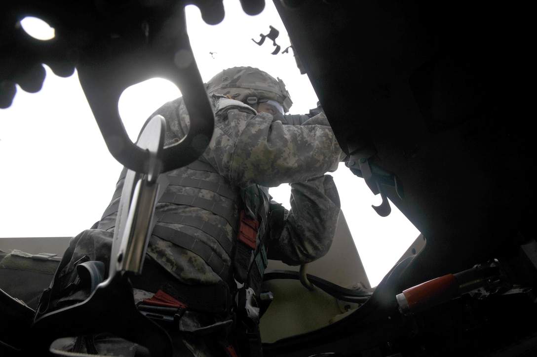 Fort Hunter-Liggett - U.S. Army Reserve military police Pfc. Ryan Joe from the 341st MP Company, of Mountain View, California, fires an M249 Squad Automatic Weapon mounted on a High Mobility Multi-Purpose Wheeled Vehicle turret during a qualification table at Fort Hunter-Liggett, California, May 4. The 341st MP Co. is one of the first units in the Army Reserve conducting a complete 6-table crew-serve weapon qualification, which includes firing the M2, M249 and M240B machine guns both during the day and night. (U.S. Army photo by Sgt. Marco Gutierrez)