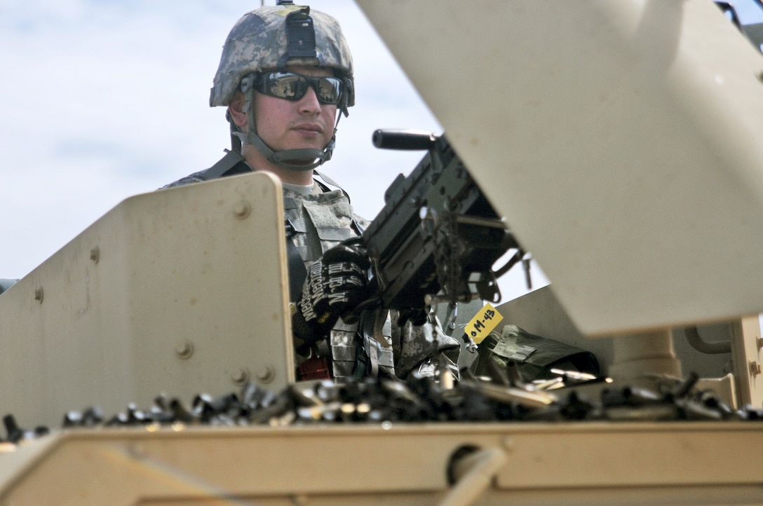 Fort Hunter-Liggett - U.S. Army Reserve military police Spc. Hector Gonzalez from the 341st MP Company, of Mountain View, California, fires an M249 Squad Automatic Weapon mounted on a High Mobility Multi-Purpose Wheeled Vehicle turret during a qualification table at Fort Hunter-Liggett, California, May 4. The 341st MP Co. is one of the first units in the Army Reserve conducting a complete 6-table crew-serve weapon qualification, which includes firing the M2, M249 and M240B machine guns both during the day and night. (U.S. Army photo by Sgt. Kim Browne)