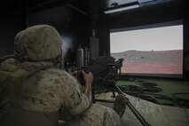 A Marine with Weapons Company, 2nd Battalion, 2nd Marine Regiment, fires on virtual targets with an Mk-19 automatic grenade launcher during training at the Indoor Simulated Marksmanship Trainer aboard Camp Lejeune, N.C., Aug. 5, 2015. The ISMT—used to train Marines on Mk 19s, M2 50-caliber machine guns, M240 medium machine guns and M16 service rifles—will be part of the Marine Corps Systems Command display at Sea Air Space May 16-18. (U.S. Marine Corps photo by Cpl. Sullivan Laramie)