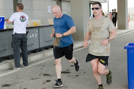 Staff Sgt. David Helm and Chief Warrant Officer 2 Shannon Bohlman, both with the Joint Visitors Bureau, Operations Company, Headquarters and Headquarters Battalion, 101st Airborne Division (Air Assault), start the final lap of the 15-kilometer route of the Kurdish Training Coordination Center Survival Fun Run held near Erbil, Iraq, May 6, 2016. The Morale, Welfare and Recreation event consisted of the choice between a 5-, 10- or 15-kilometer route with obstacles spread throughout and allowed Soldiers to have fun and build camaraderie with their peers. (U.S. Army Photo by Staff Sgt. Peter J. Berardi)