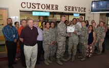 Airman 1st Class Jourdan Coleman, 47th Force Support Squadron career development apprentice, accepts the “XLer of the Week” award from Col. Thomas Shank, left, 47th FTW commander, and Chief Master Sgt. Teresa Clapper, right, 47th FTW command chief, here, May 4, 2016. The XLer is a weekly award chosen by wing leadership and is presented to those who consistently make outstanding contributions to their unit and Laughlin. (U.S. Air Force photo/Airman 1st Class Brandon May)