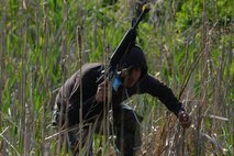 A simulated armed intruder rushes to the flight line during a training scenario for Exercise Beverly Herd 16-01 May 11, 2016, at Osan Air Base, Republic of Korea. BH 16-01 is a week-long readiness exercise for the 51st Fighter Wing that includes a plethora of scenarios like chemical, biological, radioactive, and nuclear response, active shooter and opposing forces. (U.S. Air Force photo by Senior Airman Dillian Bamman/Released)