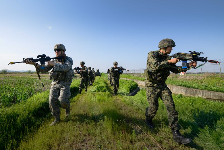Republic of Korea army special operations forces members and a 51st Security Forces Squadron fire team work together during a training scenario for Beverly Herd 16-01 May 11, 2016, at Osan Air Base, Republic of Korea. BH 16-01 is a week-long readiness exercise for the 51st Fighter Wing that includes a plethora of scenarios like chemical, biological, radioactive, and nuclear response, active shooter and opposing forces. (U.S. Air Force photo by Senior Airman Dillian Bamman/Released)