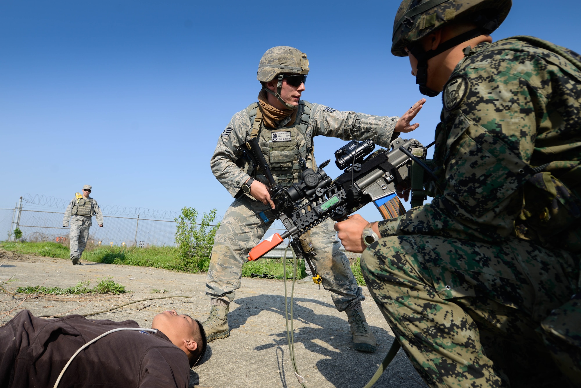 Staff Sgt. John Gavin, center, 51st Security Forces Squadron fire team leader, issues instructions to disarm simulated opposing forces during a training scenario for Beverly Herd 16-01 May 11, 2016, at Osan Air Base, Republic of Korea. BH 16-01 is a week-long readiness exercise for the 51st Fighter Wing that includes a plethora of scenarios like chemical, biological, radioactive, and nuclear response, active shooter and opposing forces. (U.S. Air Force photo by Senior Airman Dillian Bamman/Released)