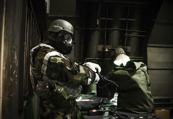 Master Sgt. Anthony Lemos, 51st Aircraft Maintenance Squadron specialist section, dons his chemical protection suit during a simulated missile attack May 10, 2016, during Exercise Beverly Herd 16-01 at Osan Air Base, Republic of Korea.  The Joint Service Lightweight Integrated Suit Technology helps protect against chemical and biological agents, radioactive fallout particles and battlefield contaminants when properly paired with the chemical protective mask. BH 16-01 is a week-long readiness exercise for the 51st Fighter Wing that includes a plethora of scenarios (U.S. Air Force photo by Tech. Sgt. Travis Edwards/Released) 