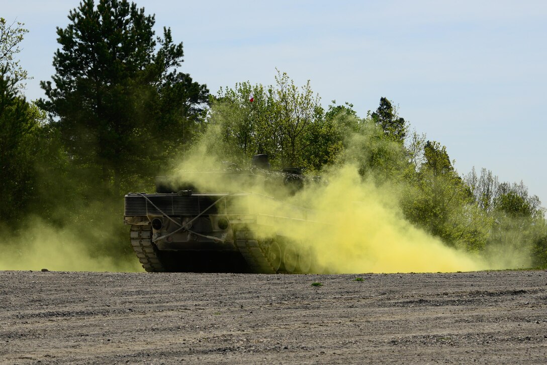 Polish soldiers in a Leopard tank conduct operations while under a simulated chemical attack during the Strong Europe Tank Challenge in Grafenwoehr, Germany, May 10, 2016. Army photo by Pfc. Emily Houdershieldt