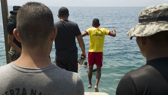 An enlisted Honduran Navy trainee jumps in the water during a swimming aptitude test April 4, 2016, on the northern coast of Honduras. The trainees took part in the first ever consolidated infantry training program in the Navy, giving them a common set of skills and knowledge to pull from in the future. 