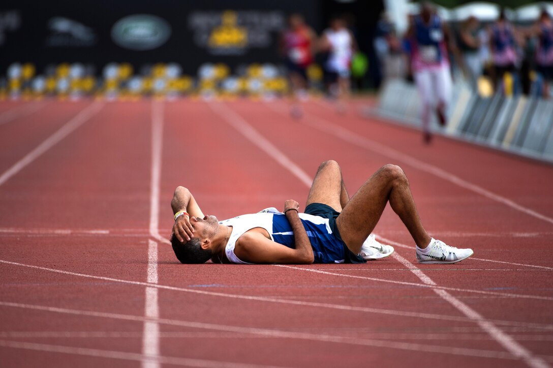 Djamel Mastouri, a member of France's team, collapses after winning a distance running event during the 2016 Invictus games in Orlando, Fla., May 10, 2016. DoD photo by EJ Hersom
