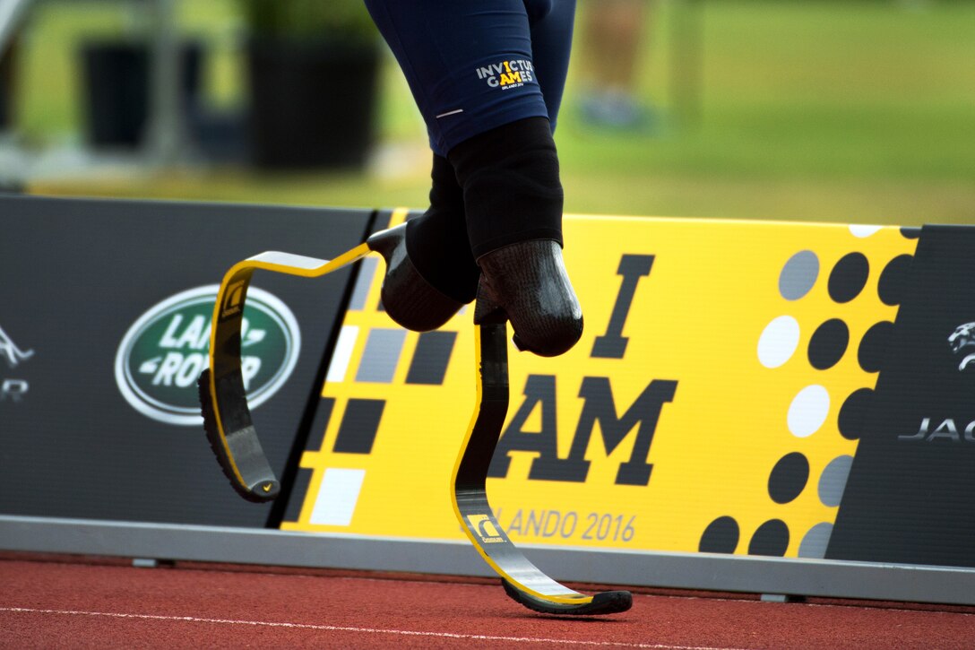 An athlete runs past the 2016 Invictus Games logo during a racing event at the games in Orlando, Fla., May 10, 2016. DoD photo by EJ Hersom